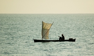 Local fisherman in typical dug-out canoe